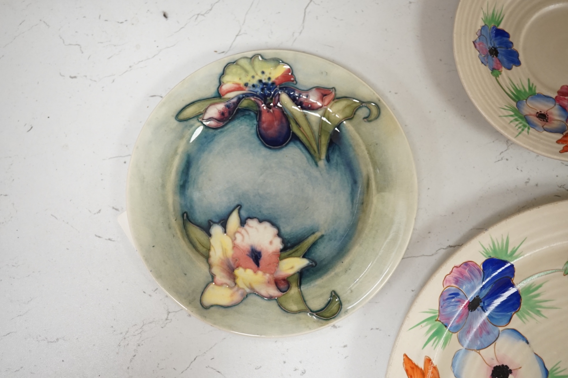 A pair of Moorcroft side plates and two plates Clarice Cliff plates. Condition - fair to good